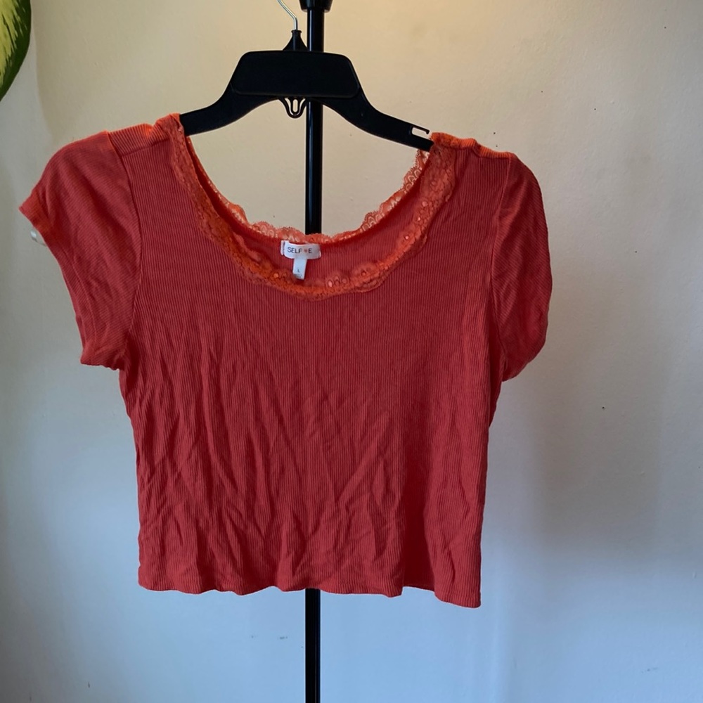 Orange crop top with lace trim. Size L